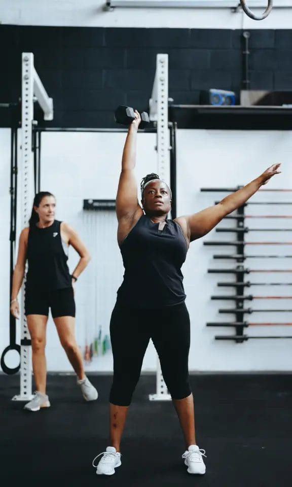 Woman training with dumbbell