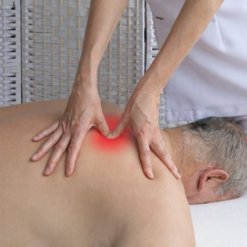 Physical therapist working on a client shoulder